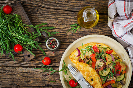 Omelet with tomatoes, zucchini and mushrooms. Omelette breakfast. Healthy food. Top view. Flat layの写真素材