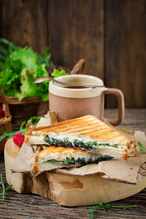 Panini sandwich with cheese and mustard leaves. Morning coffee. Village breakfastの写真素材