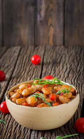 Steamed white beans with vegetables in tomato sauce. Vegan food. Asian meal.の写真素材