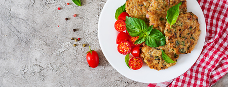 Spicy vegan burgers with rice, chickpeas and herbs. Salad tomato and basil. Vegetarian food. Top view. Banner. Flat layの写真素材