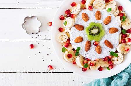 Vegan almond milk chia seeds pudding  with banana and kiwi. Detox and healthy superfoods breakfast bowl concept. Overhead, top view, flat lay.の写真素材