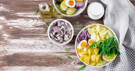 Traditional  salad of salted herring fillet, eggs, fresh apples,  red onion  and potatoes. Kosher food. Scandinavian cuisine. Top view. Flat layの写真素材