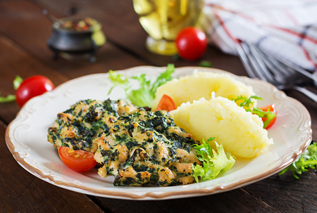 Baked steak chopped chicken fillet with spinach and a side dish of mashed potatoes. European cuisine. Dietary food.の写真素材