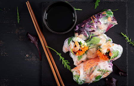 Vegetarian vietnamese spring rolls with spicy shrimps, prawns,  carrot, cucumber, red cabbage and rice noodle. Seafood. Tasty meal.  Top view, flat lay, copy spaceの写真素材