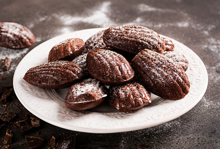 Chocolate cookies. Homemade Chocolate Madeleines on dark table. French cuisine.