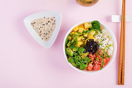 Buddha bowl with rice, mango, avocado and salmon. Healthy food concept. Top view. Flat lay
