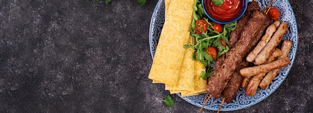 Turkish and Arabic Traditional Ramadan mix kebab plate. Kebab adana, lamb and beef on lavash bread with tomato sauce. Banner. Top viewの写真素材