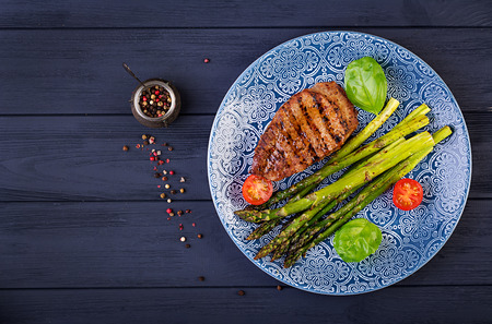 Barbecue grilled beef steak meat with asparagus and tomato. Top viewの写真素材