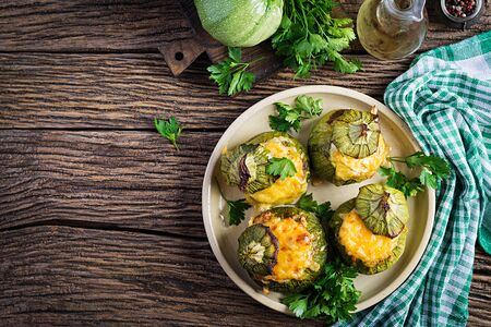 Zucchini stuffed with minced meat, cheese and green herbs. Baked in oven. Top viewの写真素材