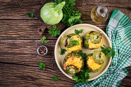 Zucchini stuffed with minced meat, cheese and green herbs. Baked in oven. Top viewの写真素材