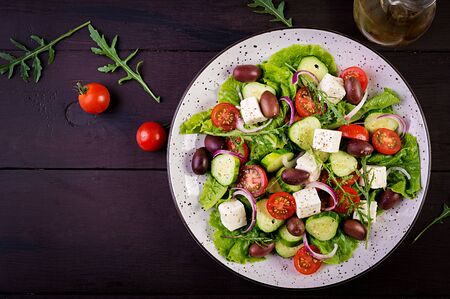 Greek salad with fresh vegetables, feta cheese and kalamata olives. Healthy food. Top viewの写真素材
