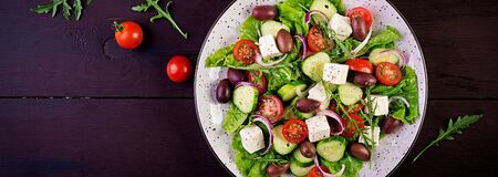 Greek salad with fresh vegetables, feta cheese and kalamata olives. Healthy food. Banner. Top viewの写真素材