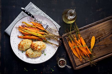 Baked organic carrots with thyme and cutlet/meatball chicken meat and zucchini. Diet food. Top viewの写真素材