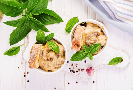 Baked mushroom julienne with chicken, cheese and toast in  pots. Top viewの写真素材