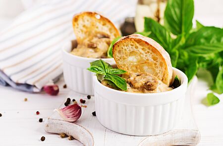 Baked mushroom julienne with chicken, cheese and toast in  pots.の写真素材