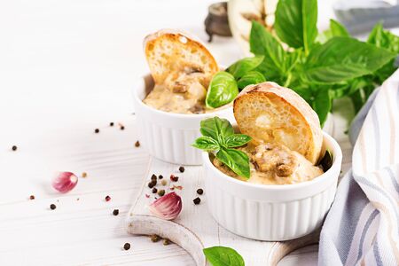 Baked mushroom julienne with chicken, cheese and toast in  pots.の写真素材
