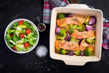Baked salmon fillet with broccoli, red onion and lemon. Top view, overheadの写真素材