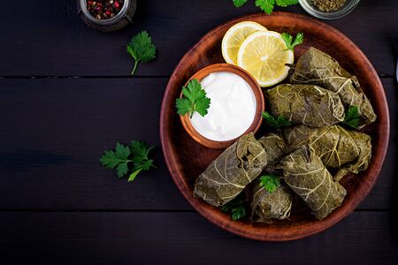 Dolma. Stuffed grape leaves with rice and meat on dark table. Middle eastern cuisine. Top view, overhead, copy spaceの写真素材
