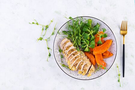 Chicken fillet with baked pumpkin and corn salad. Healthy food, ketogenic diet, diet lunch concept. Keto/Paleo diet menu. Top view, flat lay, copy spaceの写真素材