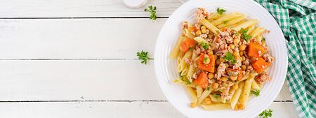 Italian pasta, penne with minced meat, chickpeas and pumpkin. Healthy food. Pasta with forcemeat. Top view, bannerの写真素材