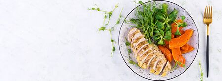 Chicken fillet with baked pumpkin and corn salad. Healthy food, ketogenic diet, diet lunch concept. Keto/Paleo diet menu. Top view, banner, copy spaceの写真素材