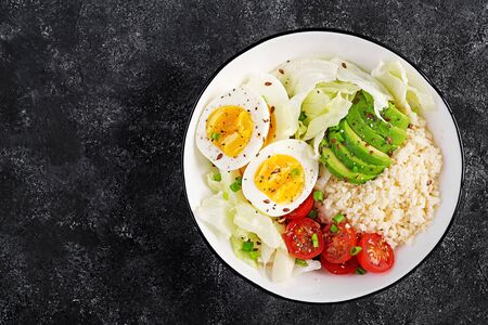 Couscous, egg and vegetables bowl. Healthy, diet, vegetarian food concept.  Vegetarian buddha bowl. Top view, overheadの写真素材