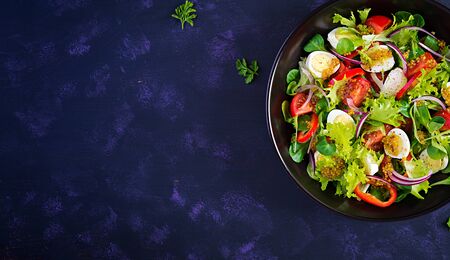 Fresh salad with vegetables tomatoes, red onions, lettuce and quail eggs. Healthy food and diet...