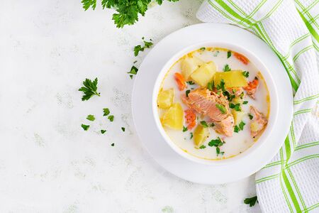 Kalakeitto. Creamy soup with salmon, potatoes, onions and carrots and  in a bowl. Finnish/ karelian cuisine. Lohikeitto. Top view, overhead, flat layの写真素材
