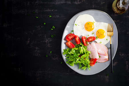 Ketogenic / paleo diet. Fried eggs, ham and fresh salad. Keto breakfast. Brunch. Top view, overheadの写真素材