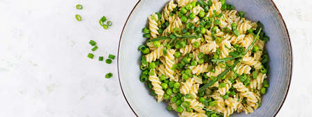 Vegan salad. Fusilli pasta with green peas and onions. Italian food. Top view. Banner. Flat lay.の写真素材