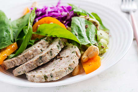 Ketogenic diet. Buddha bowl dish with meatloaf, chicken meat, avocado, cabbage and nuts. Detox and...