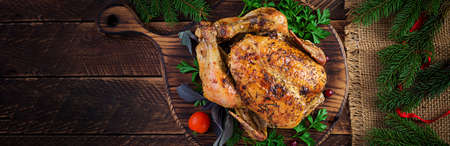 Baked turkey or chicken. The Christmas table is served with a turkey, decorated with bright tinsel....