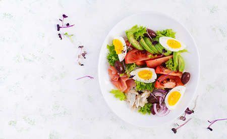 Ketogenic diet breakfast. Salt salmon and baked dorado salad with greens, tomatoes, eggs and avocado. Top view, overhead. Zero waste, eco friendly concept.の写真素材