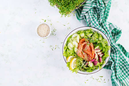 Ketogenic diet breakfast. Salt salmon salad with greens, cucumbers, celery and watermelon radish. Keto, paleo lunch. Top view, aboveの写真素材