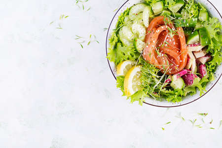 Ketogenic diet breakfast. Salt salmon salad with greens, cucumbers, celery and watermelon radish. Keto, paleo lunch. Top view, aboveの写真素材