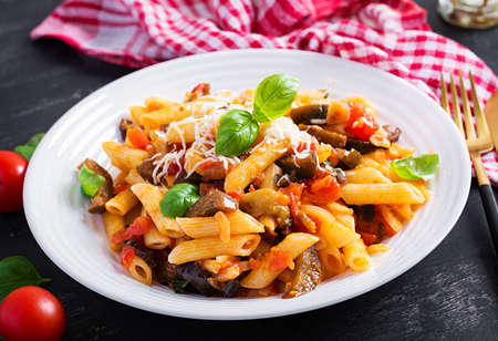 Pasta penne with eggplant. Pasta alla norma - traditional Italian food with eggplant, tomato, ricotta cheese and basil.の写真素材