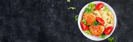 Creste pasta and chicken meatballs in tomato sauce. Top view, above, bannerの写真素材