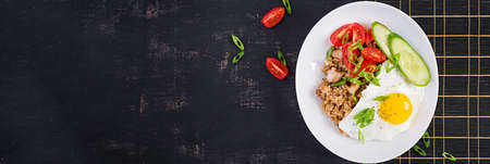 Nasi Goreng. Indonesian chicken fried rice on dark background. Nasi Goreng is an indonesian cuisine...