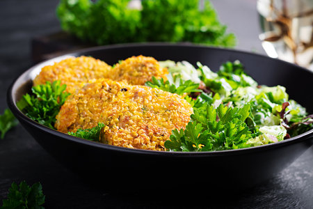 Homemade fish croquettes from white fish in cornflakes breading. Fritters from minced cod. Delicious and nutritious lunch or dinner.の写真素材