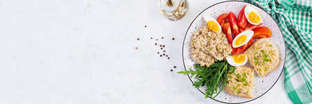 Fresh salad. Breakfast bowl with oatmeal, sandwiches with chicken rillettes, tomato and boiled egg....