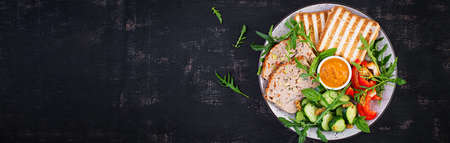 Chicken meatloaf and fresh salad and toasts. Healthy lunch or dinner. Top view, banner, overheadの写真素材