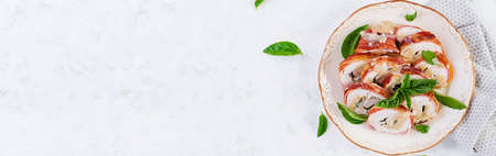 Baked chicken rolls with basil and cheese on  plate. Healthy lunch. Keto diet.Top view, banner, aboveの写真素材