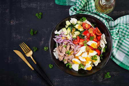 Healthy food. Tuna fish salad with eggs, lettuce, cherry tomatoes, cucumber and red onions. French cuisine. Top view, flat layの写真素材