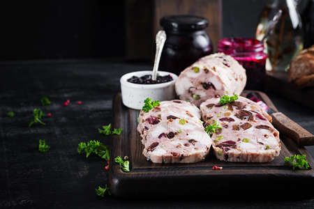 Delicious meat terrine with slice chicken, green peas and dried fruits. Meatloaf.