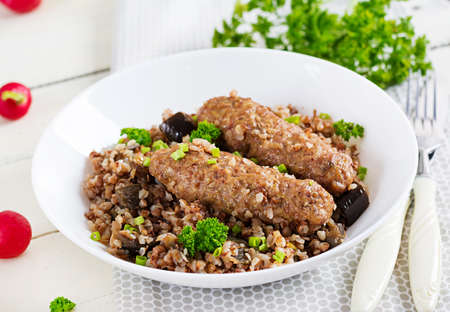 healthy dinner. Lunch bowl with buckwheat porridge, baked meat cutlets and roasted eggplants.の写真素材