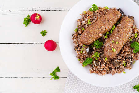 healthy dinner. Lunch bowl with buckwheat porridge, baked meat cutlets and roasted eggplants. Top view, aboveの写真素材