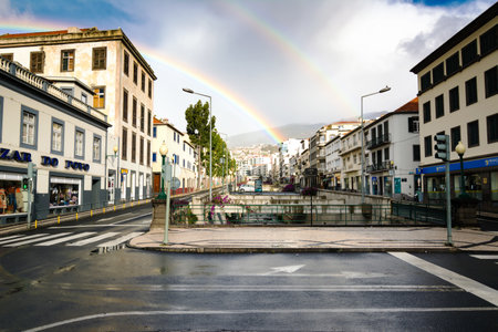FUNCAL, MADEIRA ISLAND - February 20, 2022: Funchal city street after the rain with a beautiful rainbowのeditorial素材