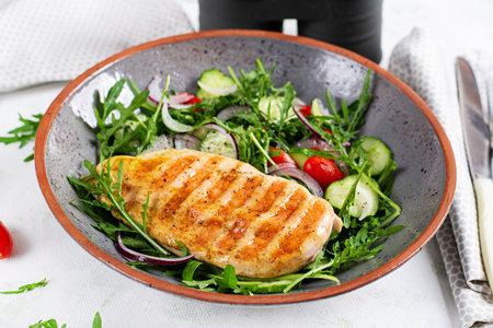 Grilled chicken fillet and fresh salad. Healthy lunch menu. Keto food.の写真素材