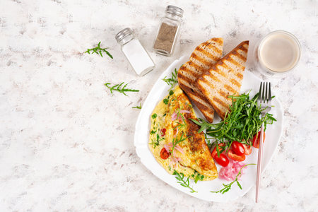 Healthy breakfast. Omelette with cheese, tomatoes and green herbs. Omelette, salad and toast. Keto, ketogenic lunch. Top view, aboveの写真素材