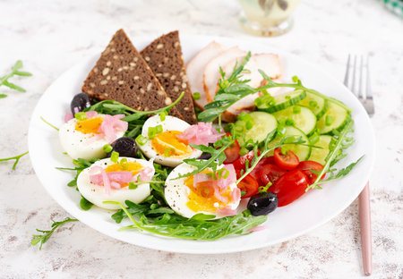 Healthy breakfast. Boiled egg, chicken ham, bread and fresh salad. Keto breakfast.の写真素材